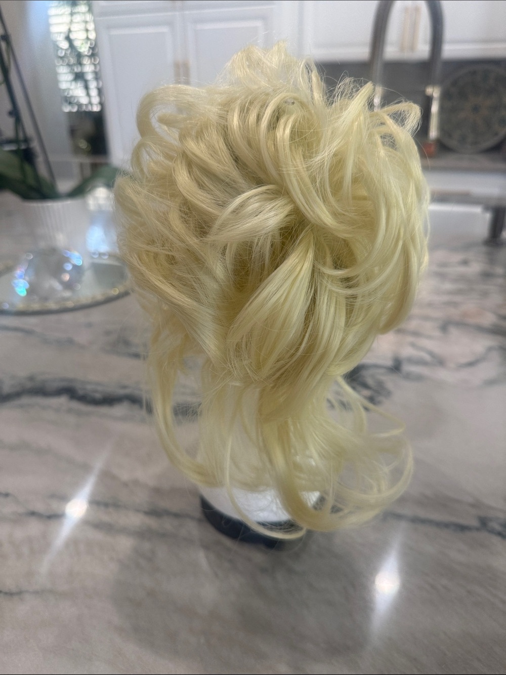 Blonde Ponytail bun with longer hair hanging down